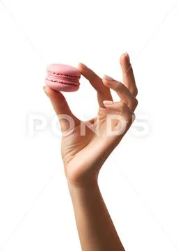 Hand holding delicate pink macaron, french pastry PSD Template