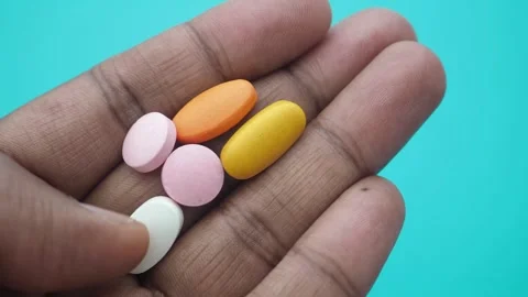 Hand holding different types of pills and tablets Stock Footage 329740411