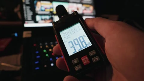 Hand Holding Digital Sound Level Meter Measuring Noise Near Laptop Stock Footage 338101519