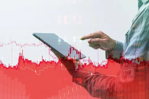 Hand holding a digital tablet and analyzing stock market downfall. Red candle Stock Photos