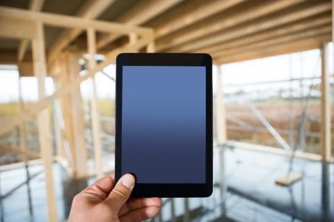 Hand Holding Digital Tablet With Blank Screen At Site Foto stock