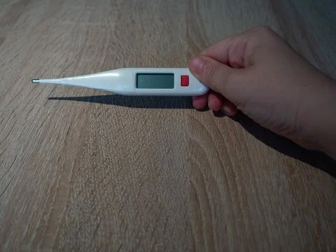 Hand Holding Digital Thermometer Stock Photos