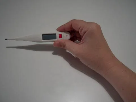 Hand Holding Digital Thermometer Stock Photos