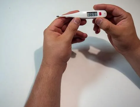 Hand Holding Digital Thermometer Stock Photos