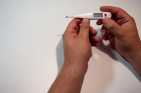 Hand Holding Digital Thermometer Stock Photos
