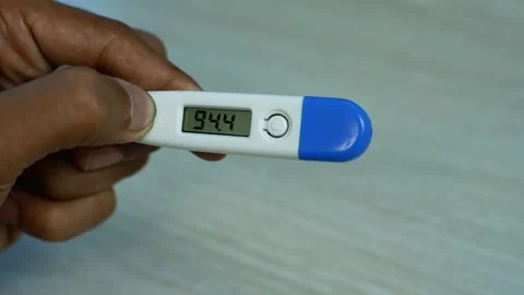Hand Holding Digital Thermometer With Temperature Reading, Close-up of a ha.. Stock Footage 346484346