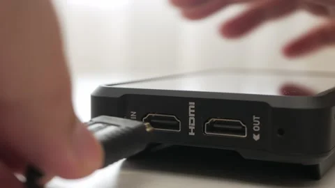 Hand holding disconnect HDMI cable from external monitor device. Plug and Stock Footage 158149548