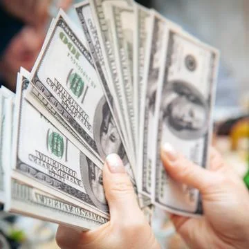 Hand holding dollar banknotes Stock Photos