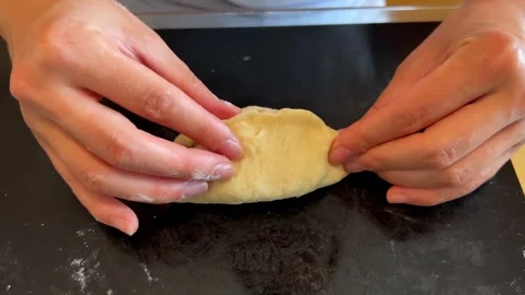 Hand holding dough with meat, preparing a staple food recipe in the kitchen Stock Footage 267460994