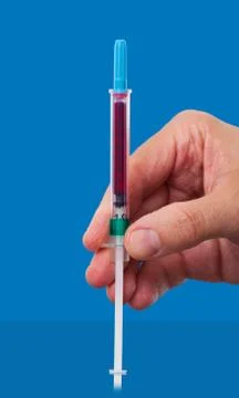 Hand holding down a syringe Stock Photos