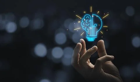 Hand holding drawing virtual lightbulb with brain on bokeh background for c.. Stock Photos