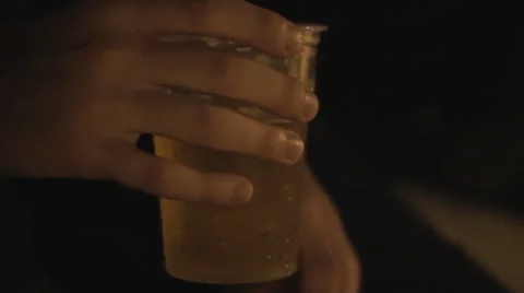 Hand holding a drink in the dark Stock-Footage 54247280