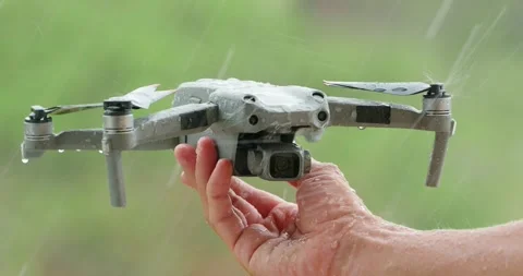 Hand holding drone copter during rain. Stock Footage 247273600