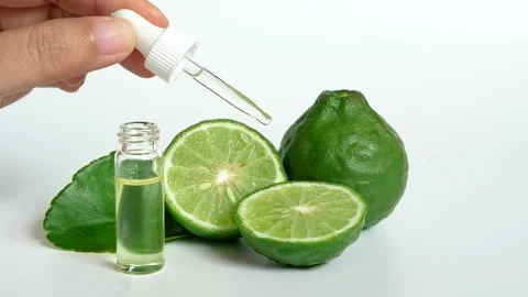 Hand holding dropper for dermatologist testing decorate with slide kaffir limes Stock Footage 133561864