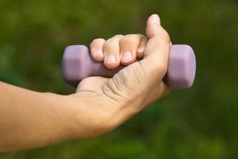 Hand holding dumbbell Stock Photos