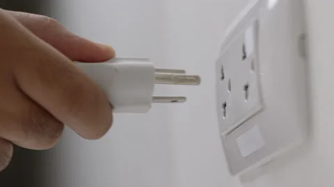 Hand holding Electric plug put on multiple socket. Electrical equipment Stock Footage 152754205
