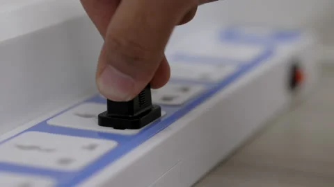 Hand holding Electric plug put on multiple socket. Electrical equipment, electri Stock Footage 152755092