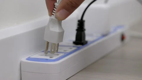 Hand holding Electric plug put on multiple socket. Electrical equipment. Stock Footage 152755093