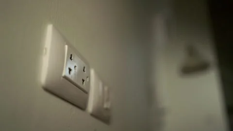 Hand holding Electric plug put on multiple socket. Electrical equipment. Stock Footage 244189267