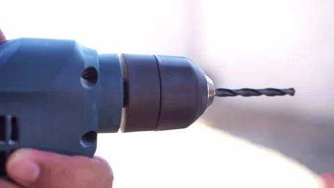 Hand holding electric power drill, testing tool with drill bit, construction Stock Footage 345289506