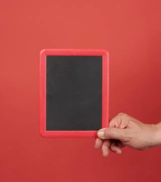 Hand  holding an empty frame on a red background Stock Photos