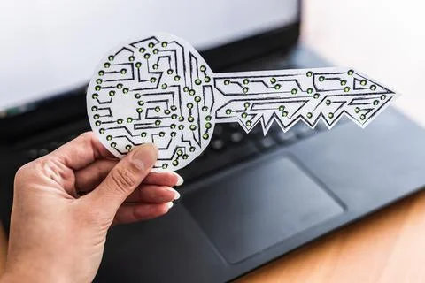 Hand holding encryption key icon made of circuits and LED lights in front of  Foto stock
