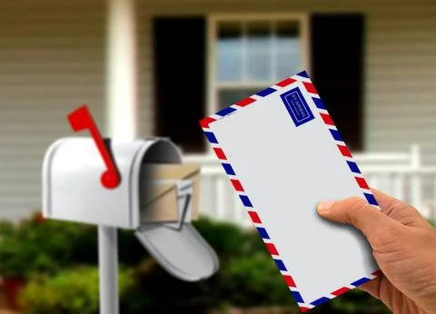 Hand holding envelope in front of a house Stock Photos