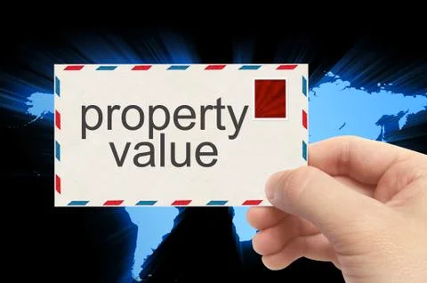Hand holding envelope with property value word on world background Stock Photos