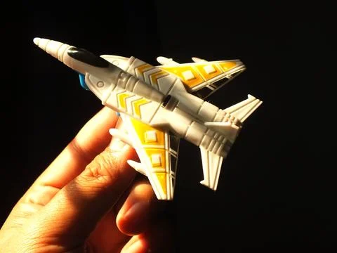 Hand holding a fighter jet plastic toys Stock Photos