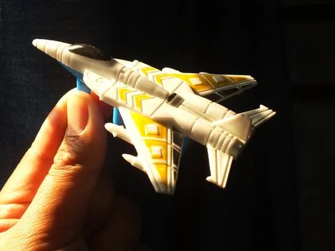 Hand holding a fighter jet plastic toys Stock Photos