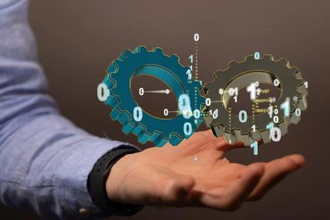 Hand holding a floating render of large gears with floating binary code Stock Photos