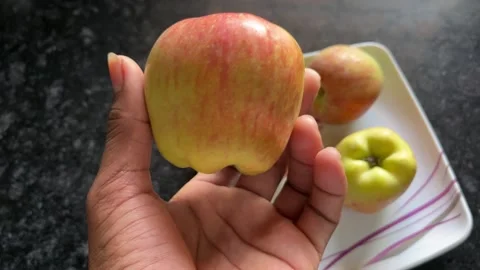 Hand Holding a Fresh Red Apple Close-Up Stock Footage 320786510