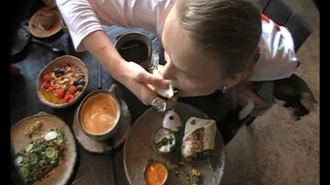 Hand holding a fresh wrap over a plate with dips Stock Footage 346148784