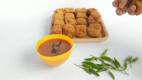 Hand holding fried tofu or sumedang tofu which Stock Footage 292414926