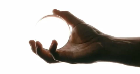 Hand Holding a Glass Sphere with Light Refraction Stock Footage 293676409