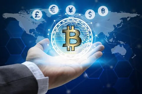 Hand holding global network using Currencies sign symbol interface of Bitcoin Stock-Fotos