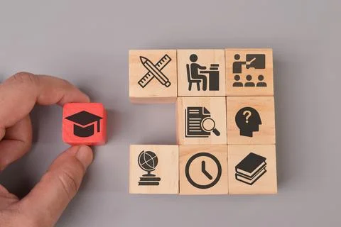 Hand holding graduation cap with learning icons. Success concept Stock Photos