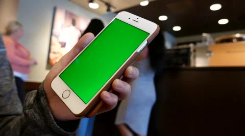 Hand holding green screen iphone inside Starbucks store Stock-Footage 67435295