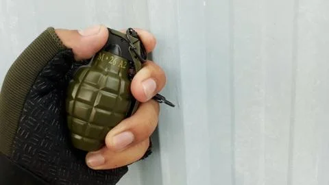 Hand holding grenade  Stock Photos