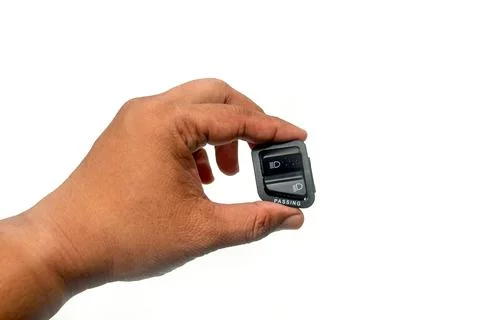 Hand holding Headlight switch button for motorcycle, for high and low beam,.. Stock Photos
