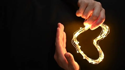 Hand holding heart made from lights Stock Footage 230636356