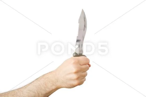 Hand holding a hunting knife in a stabbing gesture. Stock Photos