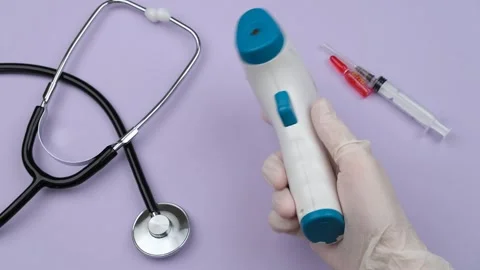 Hand Holding Infrared Thermometer Stock Footage 260244827