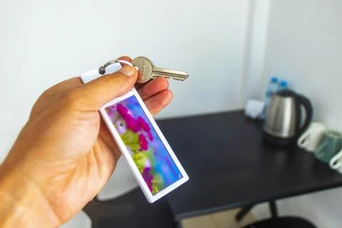 Hand holding keys from pin code box on hotel lobby wall Thailand. Stock-Fotos