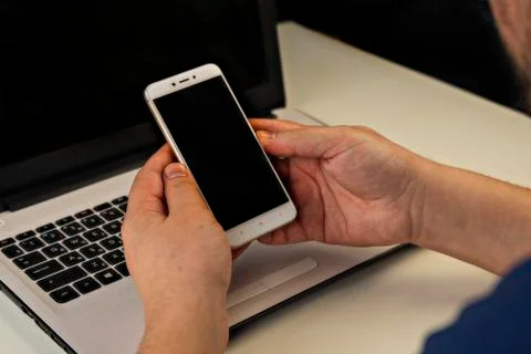A hand holding up a laptop computer Stock Photos