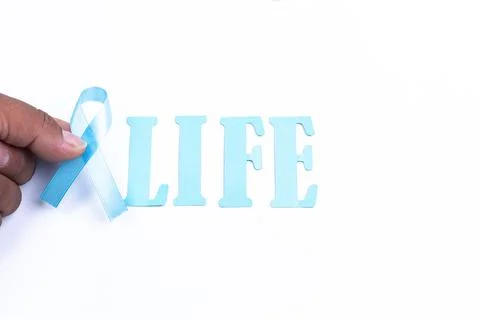 Hand holding light blue bow, with word life, white background Stock Photos