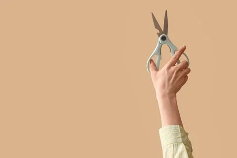Hand holding light blue kitchen shears with bottle opener, cooking and food p Stock Photos