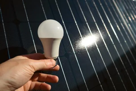 Hand holding lighting bulb for creative or design something on the backgrou.. Stock Photos
