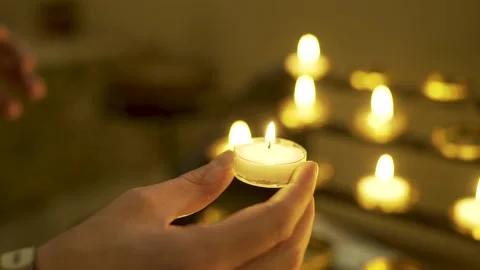 Hand holding lit candle Stock Footage 133459292