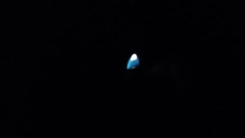 Hand holding a lit lighter in complete darkness Stock Footage 327585391